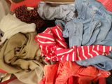 a pile of clothes in a suitcase on the floor