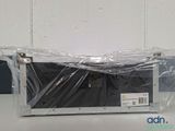a microwave that is wrapped in plastic and sitting on a table