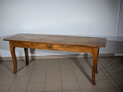 a small wooden table with a drawer on it