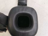 a pair of black headphones on a white surface