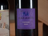 two bottles of wine sitting next to each other on a table
