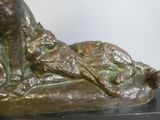 a bronze statue of a dog and a cat on a black base