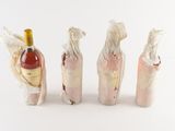 three bottles of wine wrapped in plastic wrappers with a bottle of wine in the middle