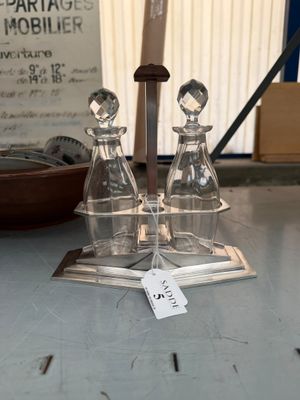 three glass bottles on a table with a price tag on it
