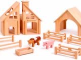 wooden toys that include a barn, a horse, and a barn