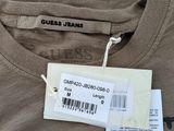 the shirt has a tag on it that says guess team