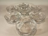 several clear glass bowls are arranged in a circle on a white surface