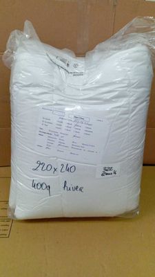 a bag of white pillows sitting on top of a cardboard box