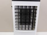 a white and black air cooler sitting on a table