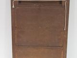 an old wooden cabinet with a rope hanging from it ' s top