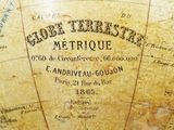 a close up of an old globe with writing on it