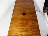 a table that has a wooden top on it
