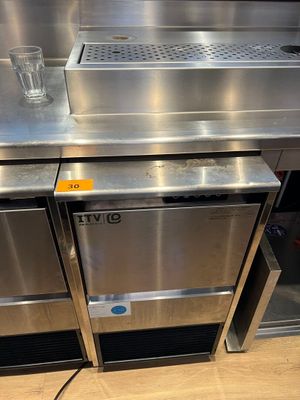 a stainless steel counter with a glass of water on it