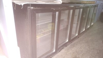 an image of a refrigerator with glass doors in a kitchen