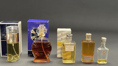 several bottles of perfume sitting next to each other on a table
