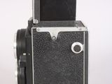 a black and silver camera on a white background