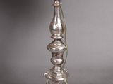 an image of a silver table lamp with a white shade on it