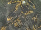 a picture of a gold and black plate with a bird on it