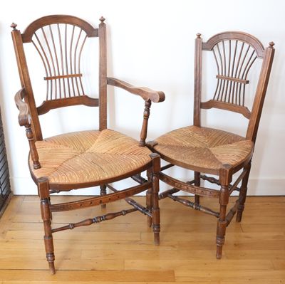 two wooden chairs sitting next to each other on a hard wood floor