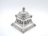 an antique silverplated sugar dish with a domed lid on a white background