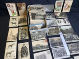several old postcards of people and animals are on a table