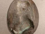 a small metal object with a face on it