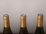 three bottles of wine that are sitting on a table