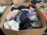 a cardboard box filled with clothes and other items