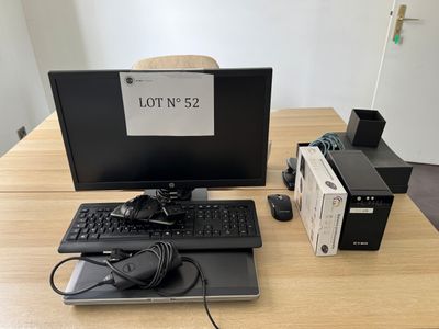 a desktop computer sitting on a desk with a lot of cords