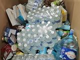 a cardboard box full of water bottles and other items