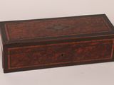 a small wooden box with a decorative design on the lid