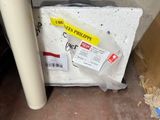 a box of toilet paper sitting on the floor next to a toilet