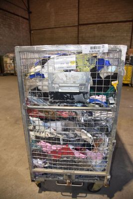 a metal cart with many items in it in a warehouse