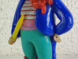 a figurine of a pirate with a toothbrush in his hand