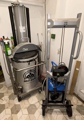 a machine that is next to a trash can in a room