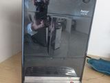 someone is taking a picture of a coffee machine on a wooden table