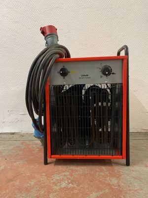 un radiateur rouge et noir posé par terre à côté d'un tuyau