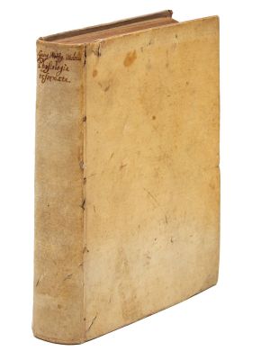 an old book with a brown cover sitting on top of a white surface