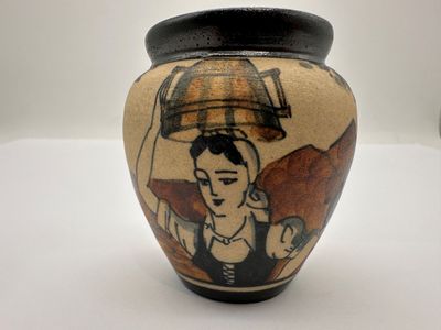 a vase with a picture of a woman on it