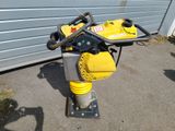 a small yellow machine that is sitting on the ground