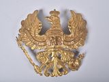 a gold brooch with a bird on it