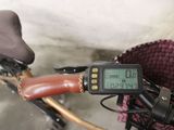 a close up of a bicycle with a digital display on the handlebar