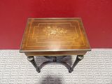 a small wooden table with a floral design on it