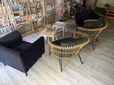 two chairs and a table in a room with bookshelves