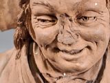 a clay sculpture of a man with a hat on