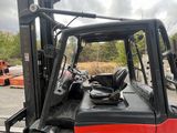 a red fork truck that is parked in the parking lot
