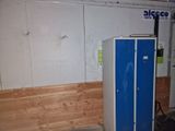 a blue refrigerator that is in a room with wood flooring
