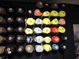 many hats hanging on the wall in the store