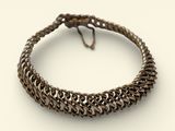 a close up of a bracelet on a white surface