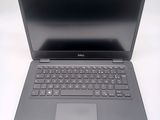 a dell laptop computer sitting on a white surface